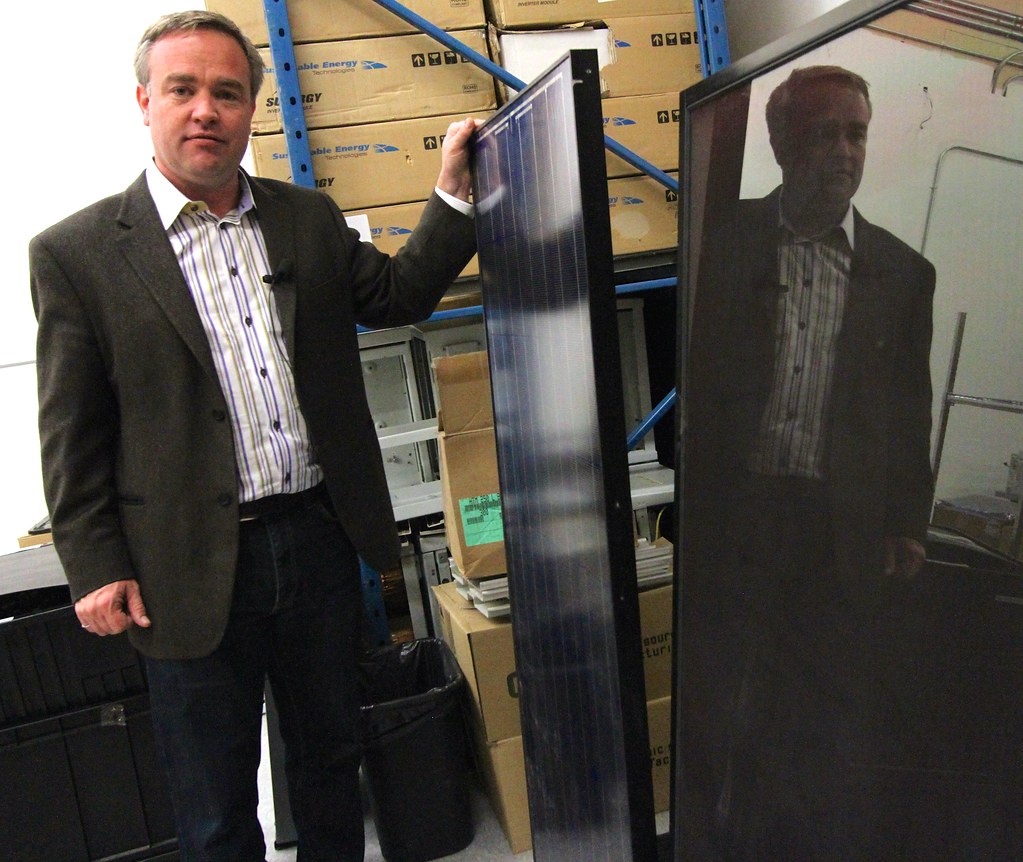 Brent Harris CTO Sustainable Energy Technologies with a conventional silcon module and a thin film solar module (right).