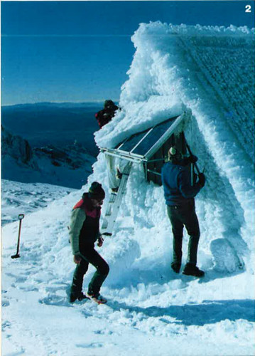 Tongariro National Park Rangers chiselling ice and snow off the solar panels which power the Dome Hut’s emergency telephone (1986-7)